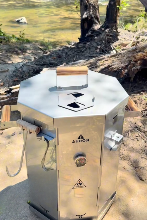 Versatile 3-in-1 outdoor cooking system for smoking, direct grilling, and hanging meat with integrated thermometer.