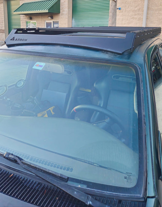 Low-profile 3rd Gen 4Runner roof rack featuring a front deflector with integrated 40 inch LED light bar mounts.