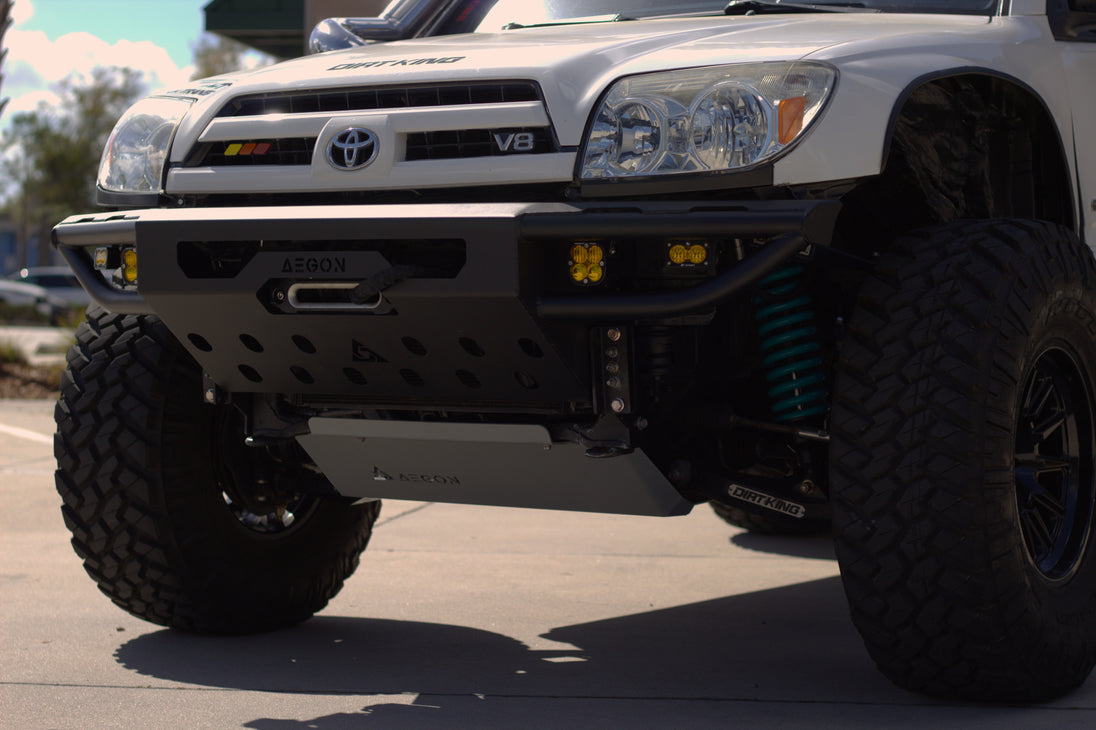 Front view of a 4th Gen Toyota 4Runner with a high-clearance steel bumper on a trail.