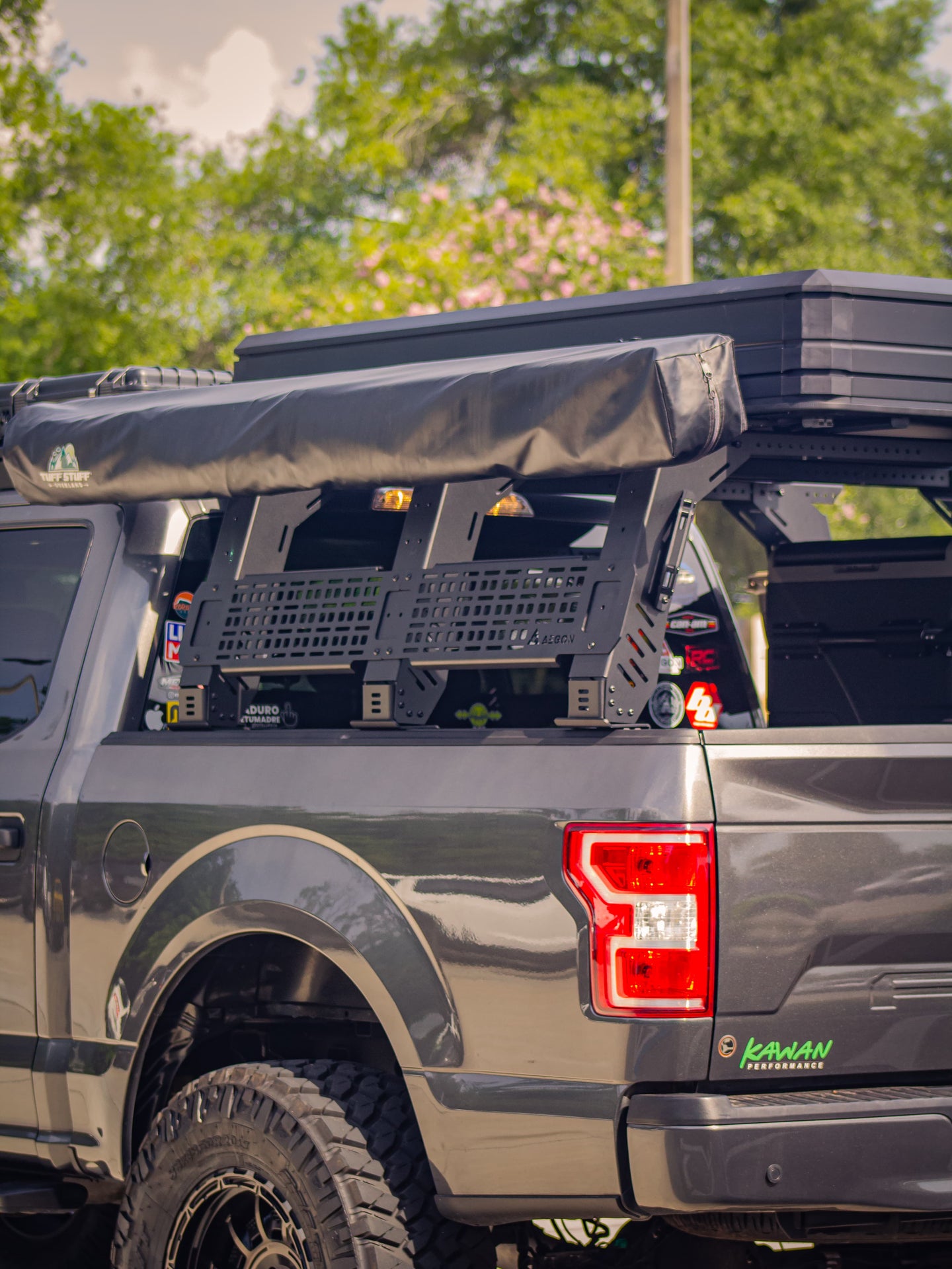 Off-road aluminum bed rack with 900 lbs dynamic load capacity for overlanding gear and tents.