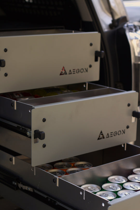 A 6-inch aluminum storage drawer installed in the back of an overland off-road truck.