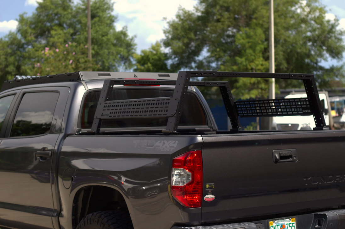 Black pickup truck with a bed rack in an outdoor setting