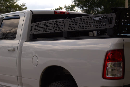 Adjustable height low-profile truck rack for reduced wind resistance on highway and trail.