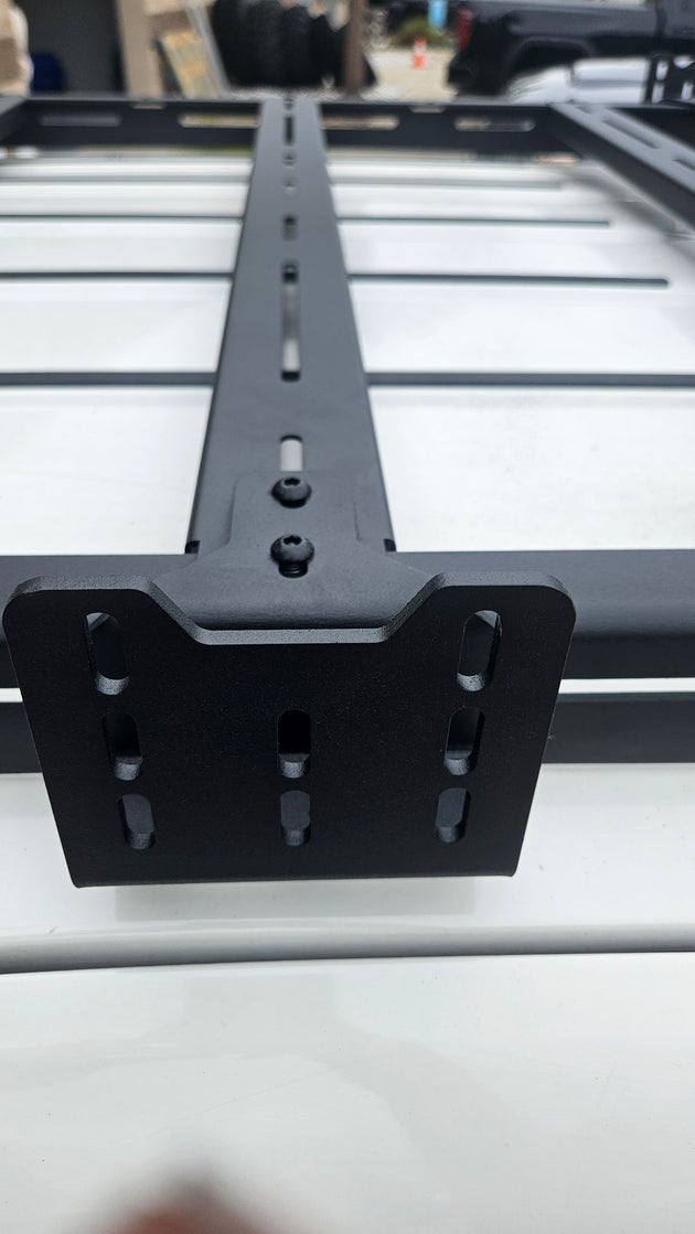 Set of 2 black powder-coated steel awning mount brackets designed specifically for AEGON roof rack systems.