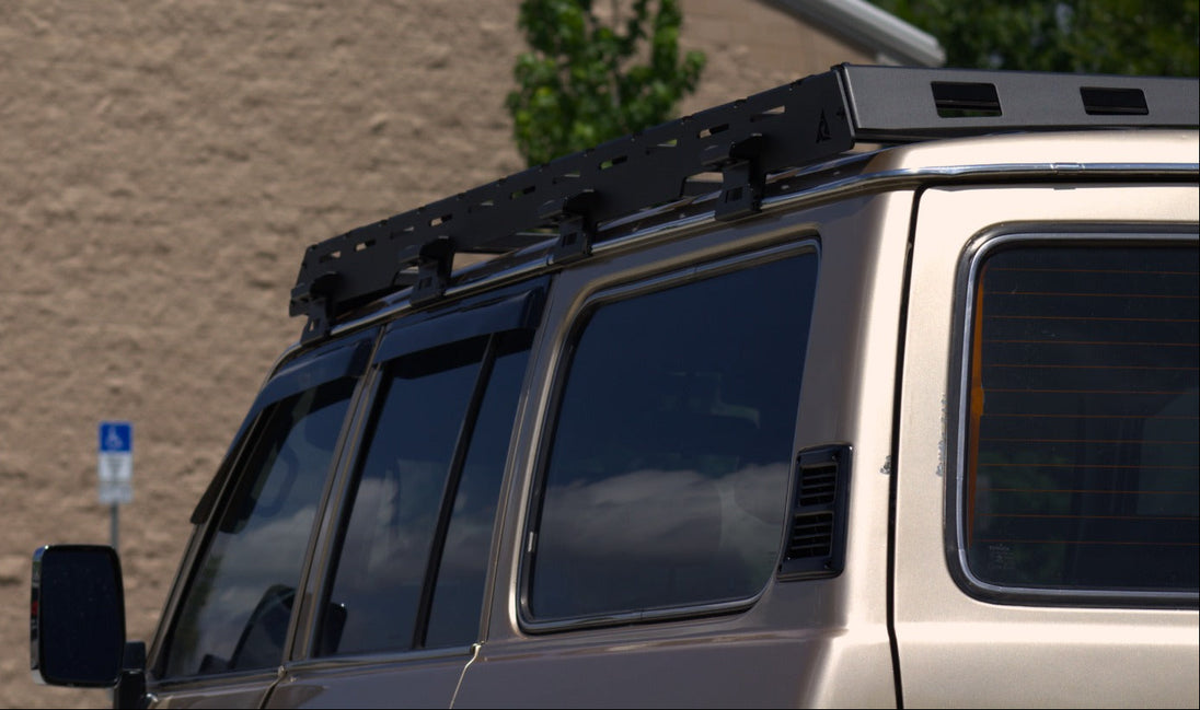 Wind deflector on a Toyota Land Cruiser FJ62 roof rack to reduce noise and drag.