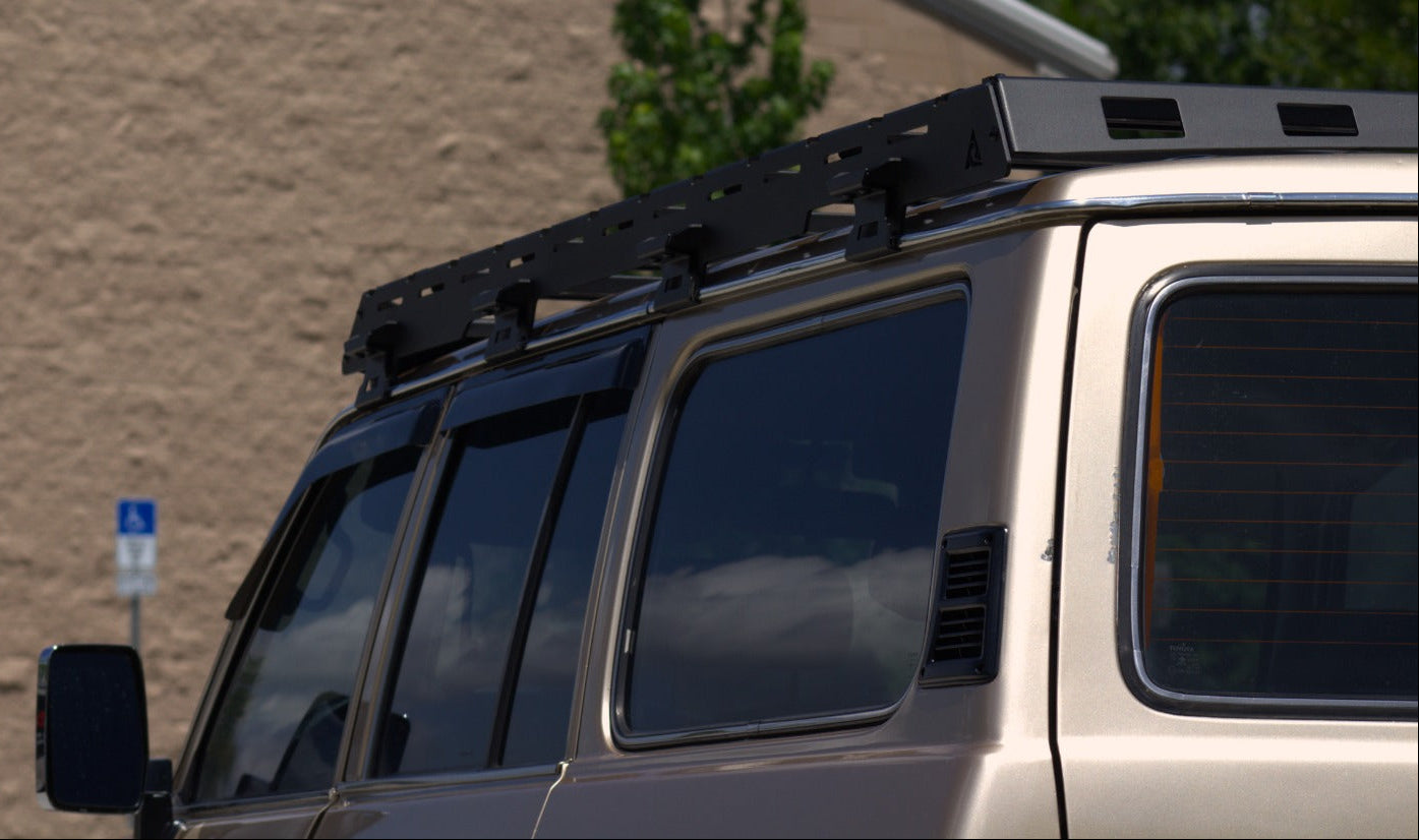Wind deflector on a Toyota Land Cruiser FJ62 roof rack to reduce noise and drag.