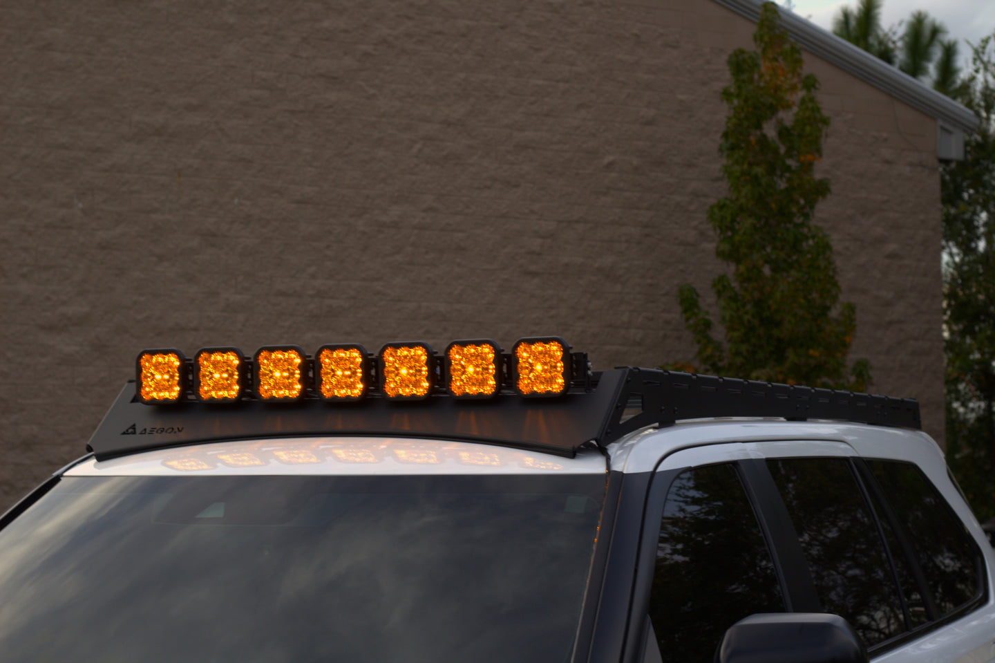 Aerodynamic roof rack for Toyota Sequoia with front wind deflectors to reduce wind noise and improve fuel efficiency.