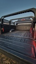 Heavy-duty bed rack featuring multiple tie-down points and integrated mounts for off-road auxiliary lighting.