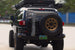 Fully built Toyota FJ Cruiser overland rig with AEGON rear bumper, spare tire carrier, and rooftop tent