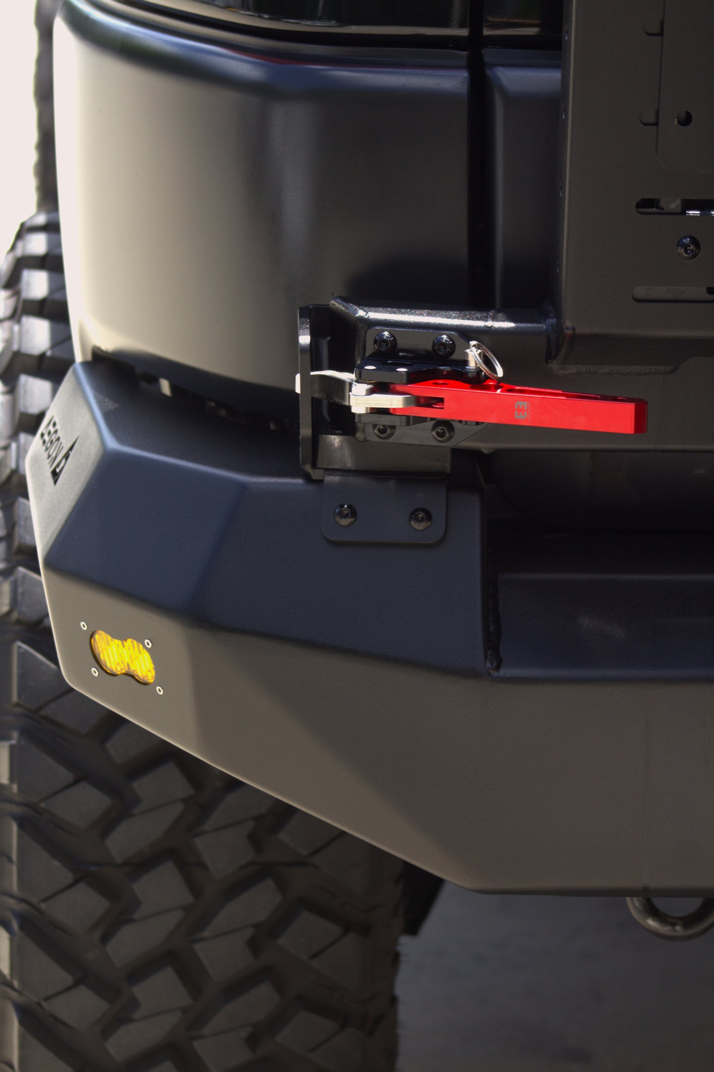 AEGON FJ Cruiser rear bumper showing the swing-out latch mechanism and amber marker light