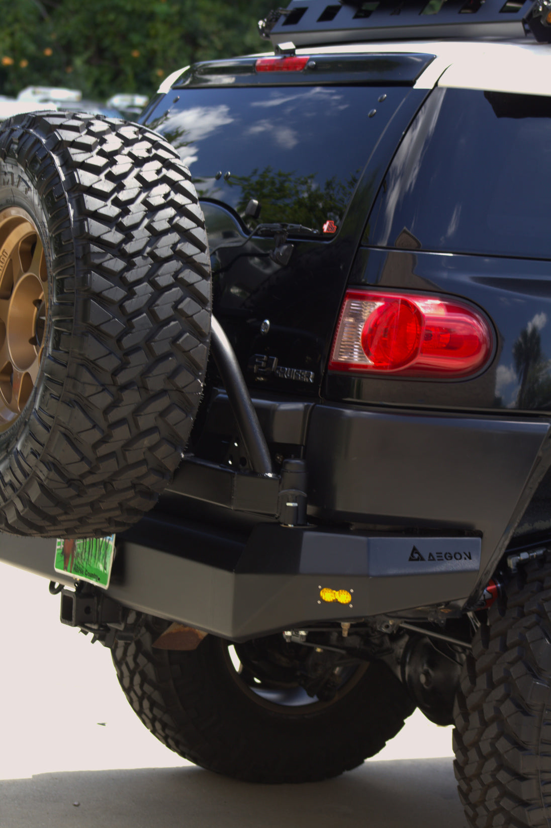 Side view of the Toyota FJ Cruiser rear end with AEGON bumper and mounted spare tire carrier