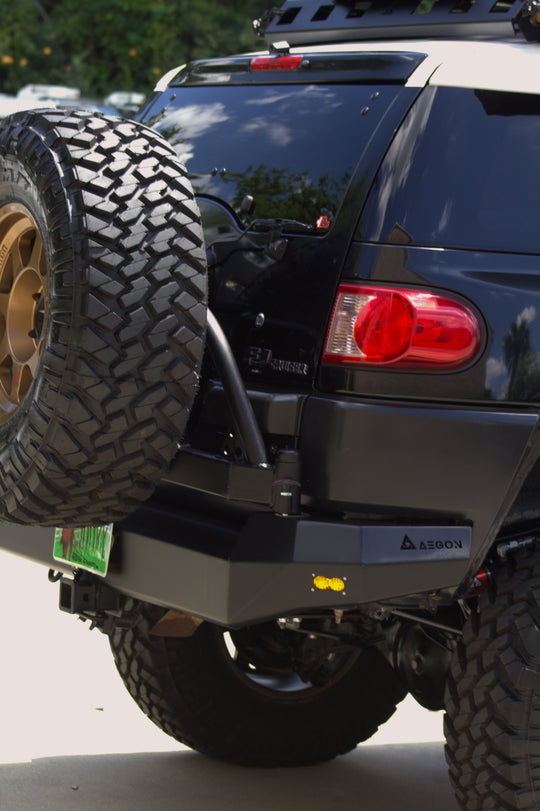 Side view of the Toyota FJ Cruiser rear end with AEGON bumper and mounted spare tire carrier