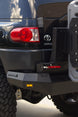 AEGON steel rear bumper installed on a Toyota FJ Cruiser, shown next to the factory Toyota badge and taillight