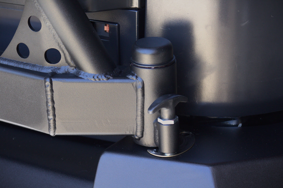 Detail of the welded hinge and locking pop-pin on the AEGON FJ Cruiser swing-out tire carrier