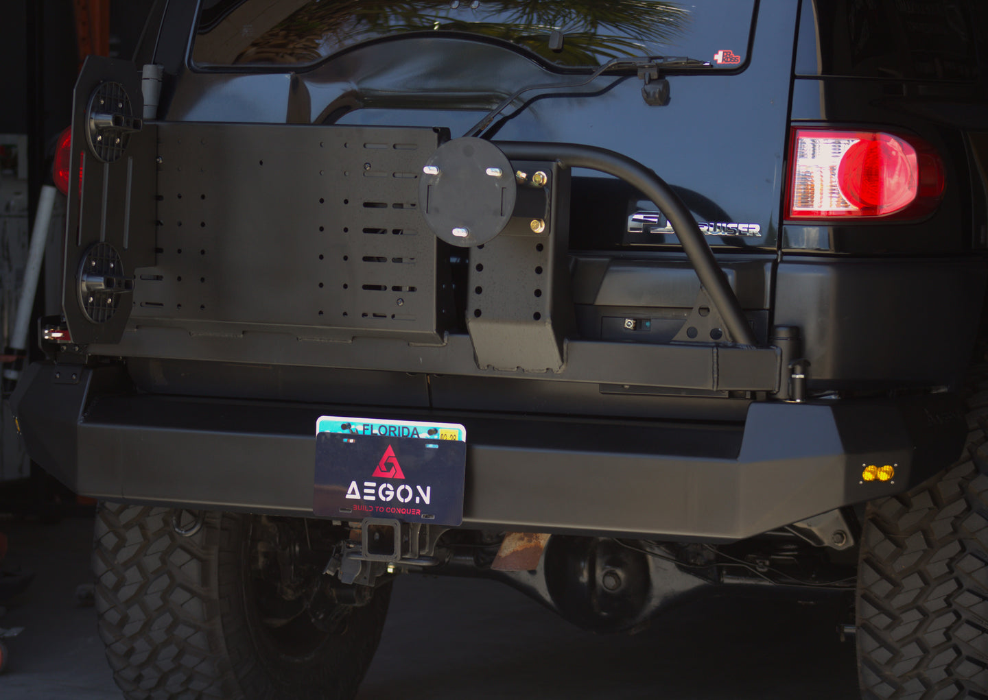 AEGON FJ Cruiser swing-out bumper panel with MOLLE accessory mounts and Built to Conquer license plate