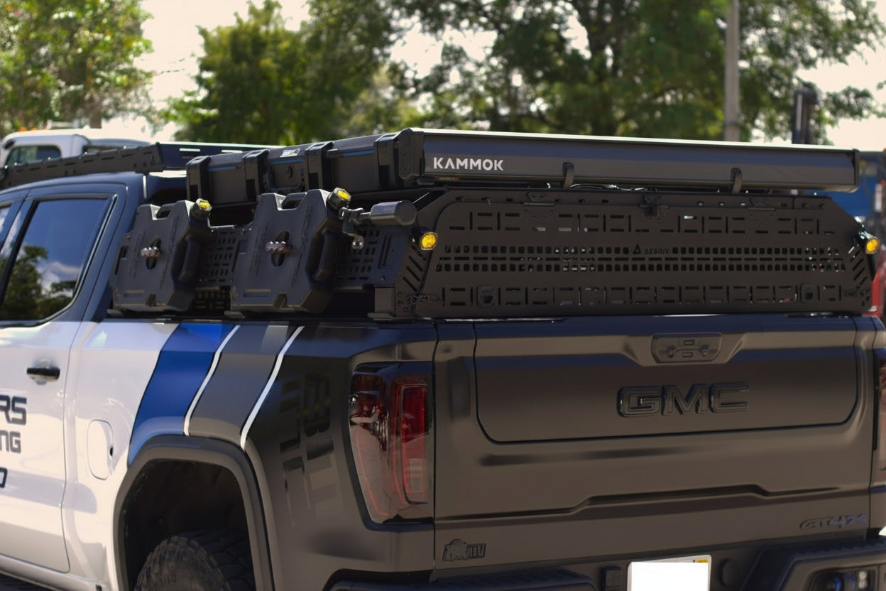 Integrated side accessory slots for mounting Rotopax fuel packs and water containers.