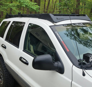 Heavy-duty steel roof rack for Jeep Grand Cherokee WJ and WG models 1999 to 2004 for off-road cargo storage.