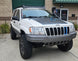 Front wind deflector for Jeep Grand Cherokee WJ roof rack with integrated mounts for a 40 inch LED light bar.