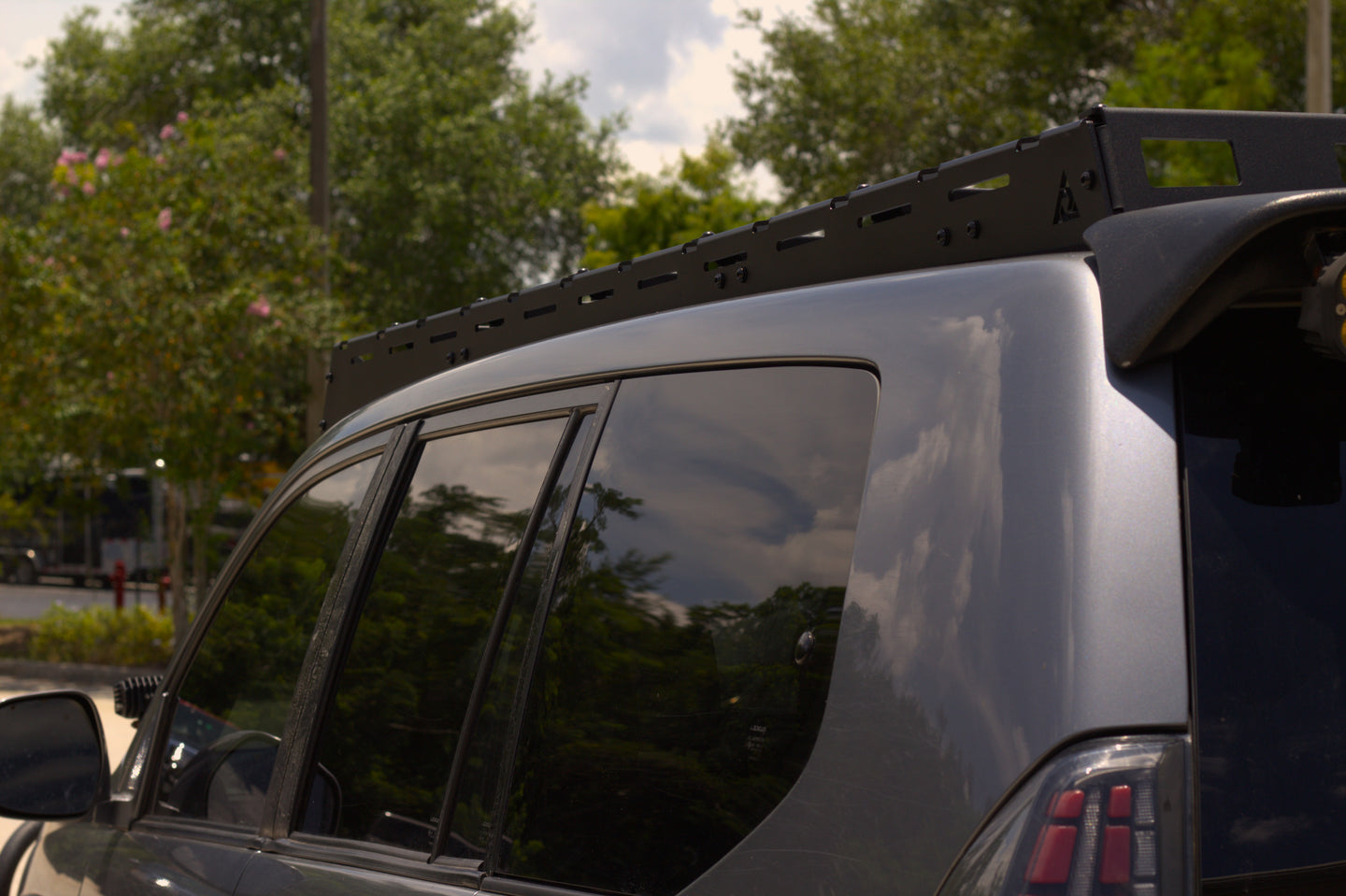 Aluminum roof rack for Lexus GX 470 with built-in light mounts for off-road auxiliary lighting and night-time trail driving.