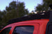 Sleek low-profile aluminum roof rack for Toyota Tacoma with an integrated wind deflector to improve fuel efficiency and reduce noise.