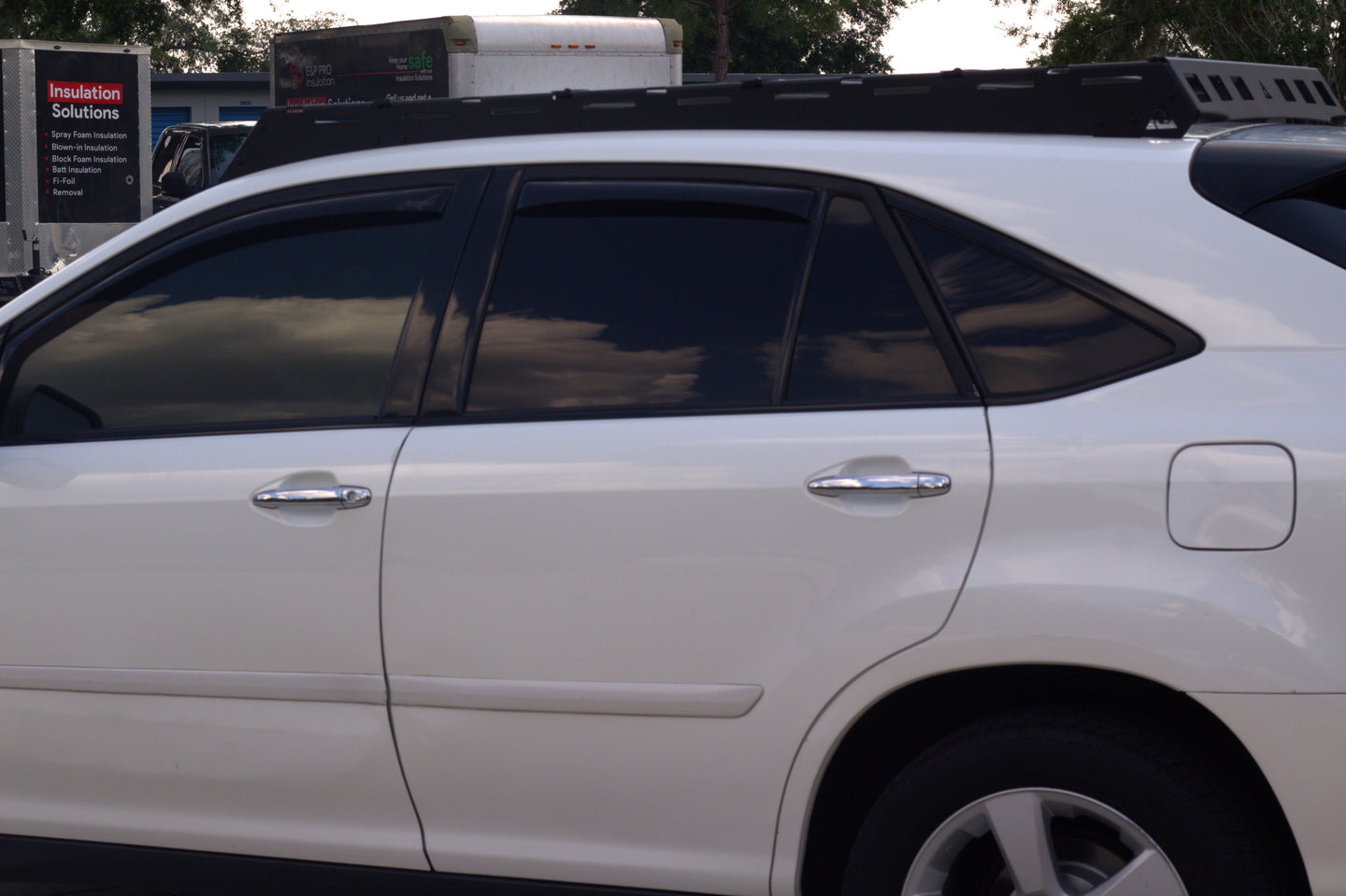 Sleek low-profile aluminum roof rack for Lexus RX 350 with wind deflectors to reduce noise and maintain fuel efficiency.