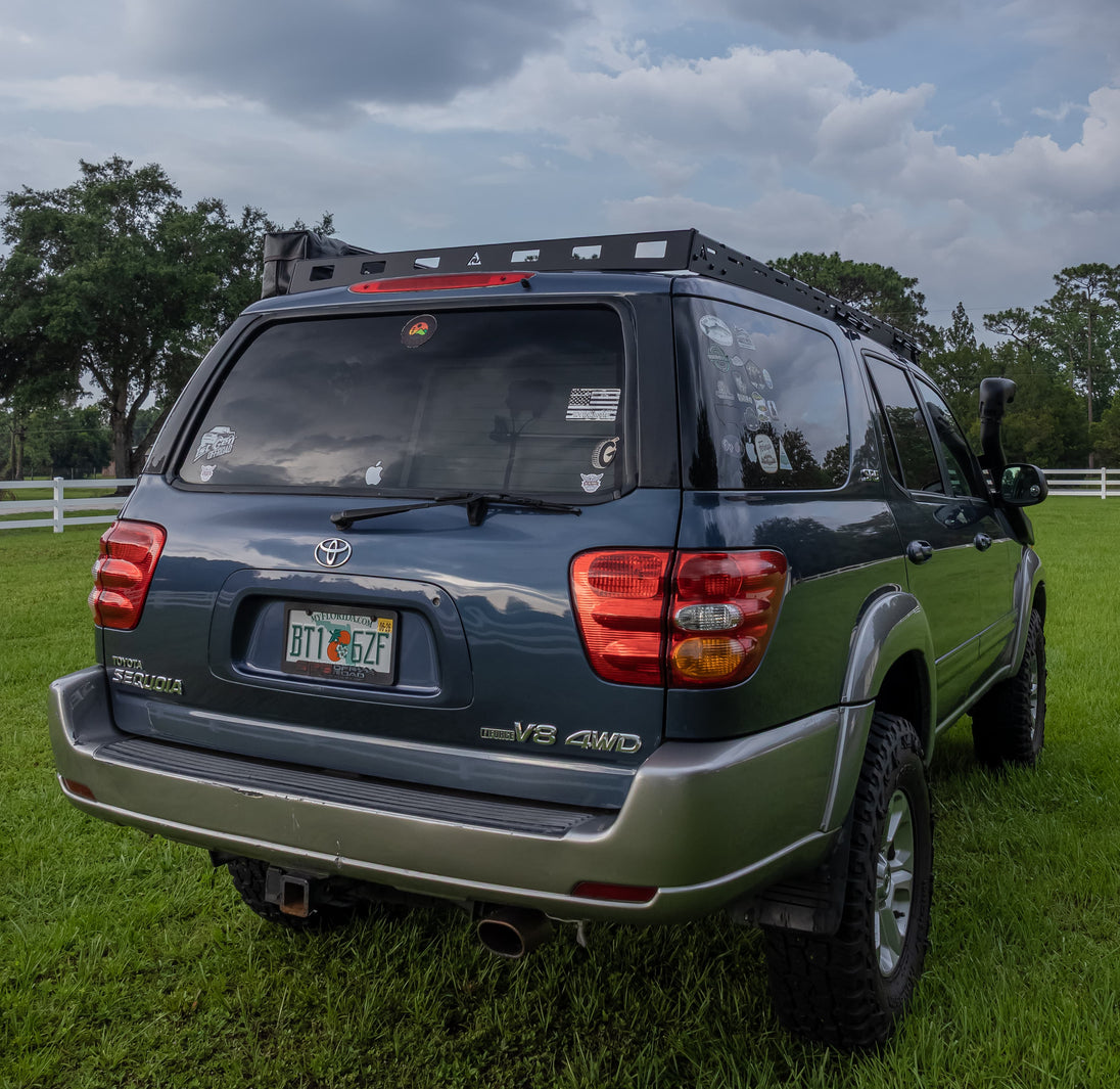 Sleek low-profile Toyota Sequoia 3rd Gen roof rack featuring integrated front light mounts for off-road LED bars.