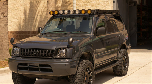 Sleek low-profile aluminum roof rack for Toyota Prado Series 95, designed to reduce wind noise.