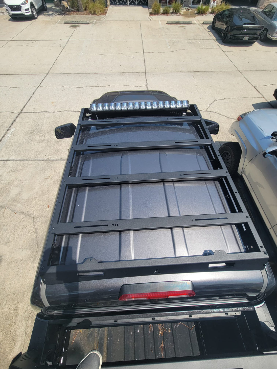 Low-profile CNC laser-cut aluminum roof rack for Toyota Tundra with 500 lbs dynamic load rating.