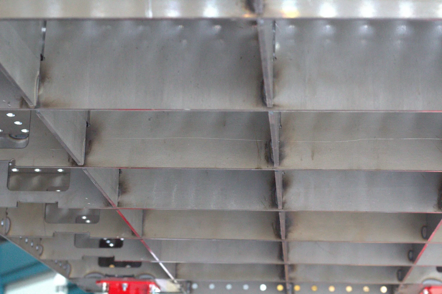 Close-up of no-treatment mill finish steel plate surface on an AEGON professional welding table.