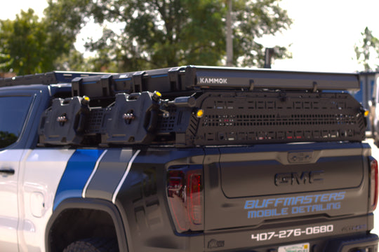 Multiple tie-down points on aluminum bed rack to keep overland gear organized and secure.