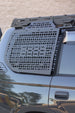 Rear window storage panel for 1996-2002 Toyota Prado showing the easy no-drill mounting hardware.