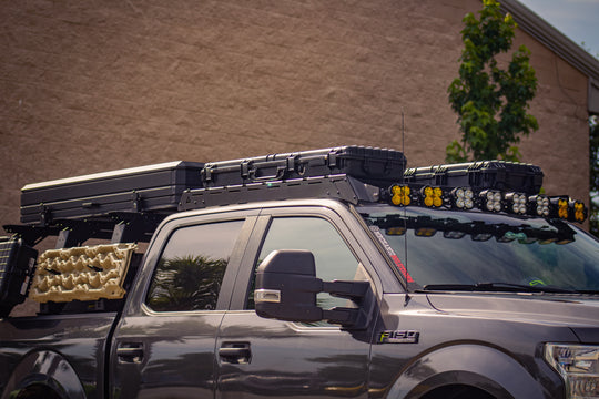 Sleek low-profile aluminum roof rack for Ford F-150 featuring easy no-drill installation and integrated light mounts.