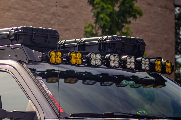 Sleek low-profile aluminum roof rack for Ford F-150 featuring easy no-drill installation and integrated light mounts.