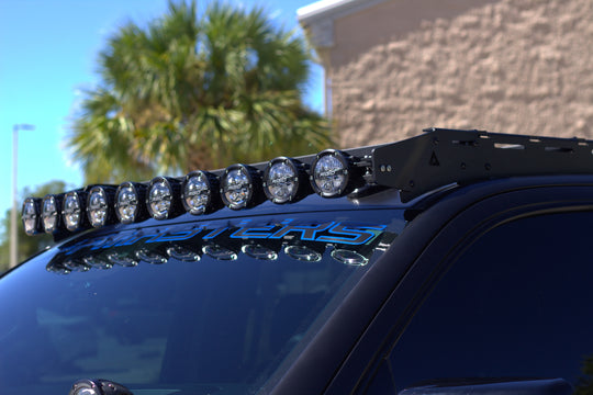 Tactical GMC Sierra 1500 roof rack with built-in front light mounts for off-road LED bars and nighttime trail driving.