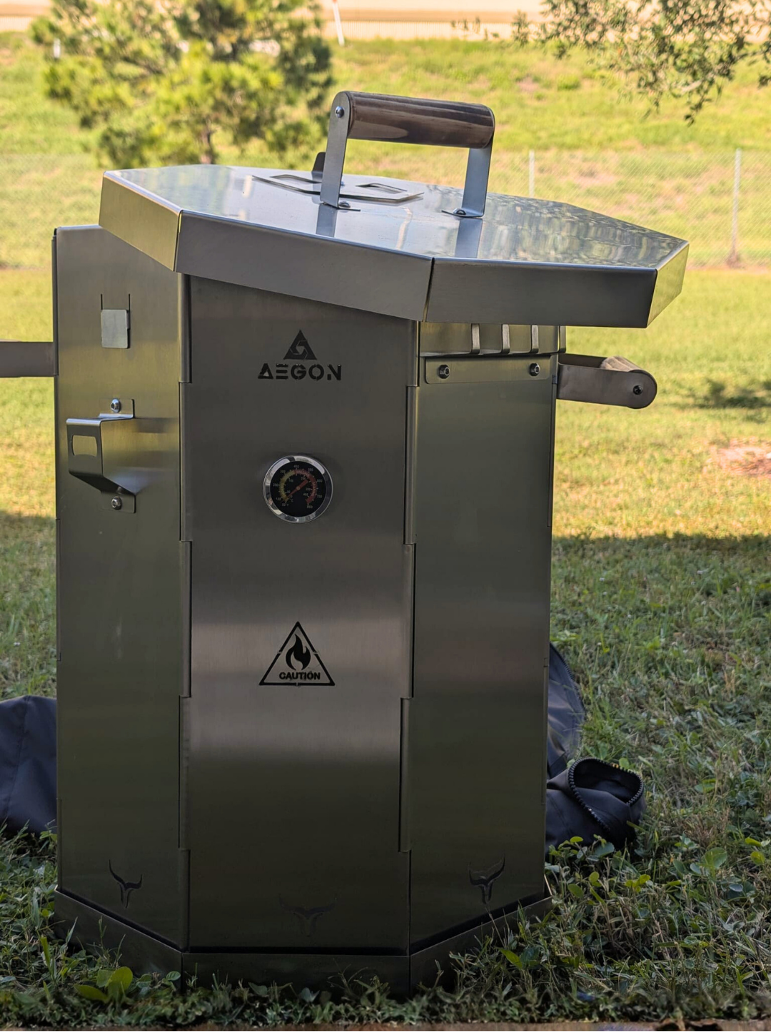 Rust-proof and heat-resistant stainless steel vertical smoker built to withstand high heat and open flame cooking.