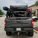 Aegon aluminum bed rack with integrated slots for mounting Rotopax fuel packs, recovery boards, and off-road tools.