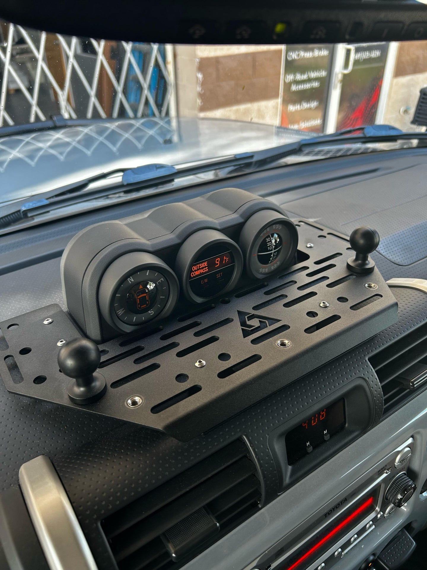Interior aluminum dashboard Molle panel for Toyota FJ Cruiser in black powder coat finish for tactical gear organization.