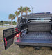 Pull-out Molle bed panel system for Toyota Tundra CrewMax 2007-2021 featuring sliding side rails and static front panel for gear access.