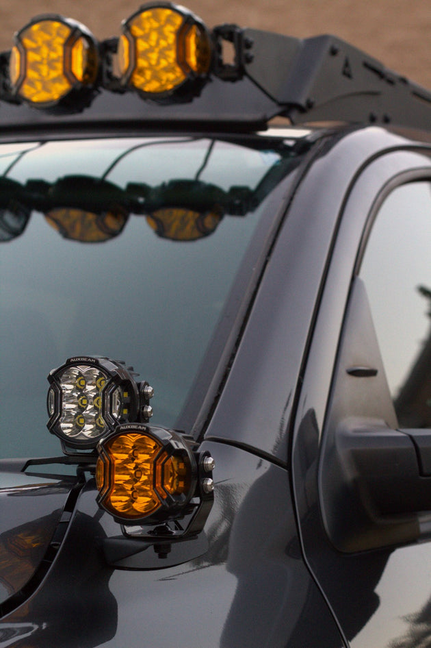 Close-up of hood side light mounts integrated with ditch light brackets on a Tundra.