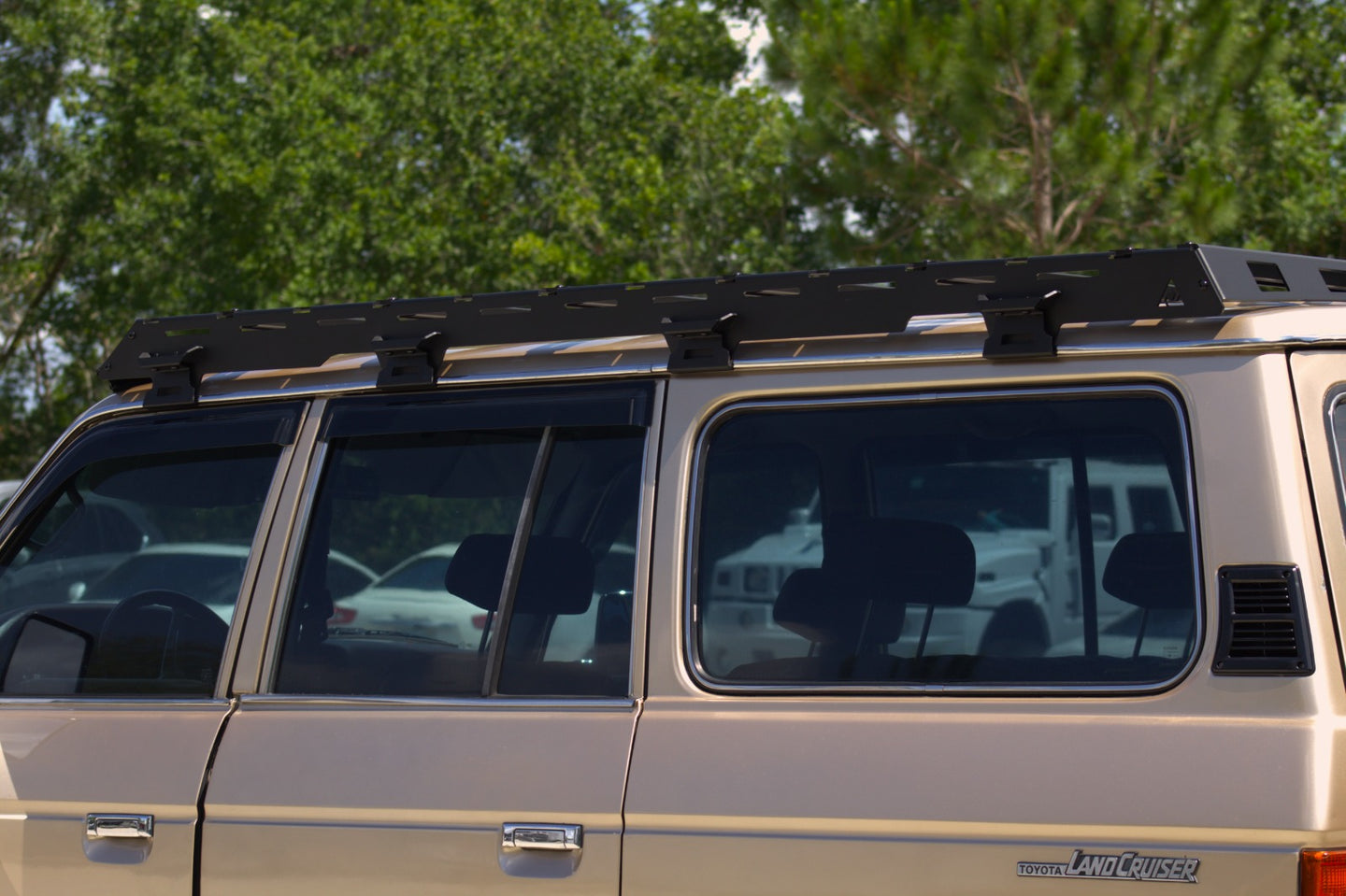 Vintage Toyota Land Cruiser FJ60 equipped with an AEGON aluminum expedition roof rack for camping.